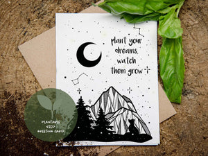 Plant Your Dreams, Watch Them Grow plantable seed card featuring mountain and nature illustration.
