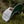 Hiking Boot, Flat Bill Hat resting on moss with a faux leather patch, designed for outdoor adventures.