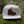 Hiking Boot, Flat Bill Hat on moss, featuring faux leather patch and adjustable snapback, perfect for outdoor adventures.