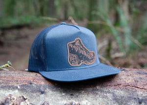 Hiking Boot, Flat Bill Hat with durable faux leather patch, crafted for outdoor adventures, designed in Canada.
