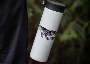 Little Whale Sticker on a white travel mug, showcasing original illustration by a Canadian artist.