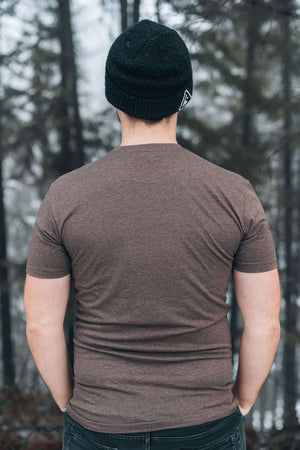 Luna Moth, Unisex T-shirt, Responsibly Made, model wearing brown T-shirt in forest setting.