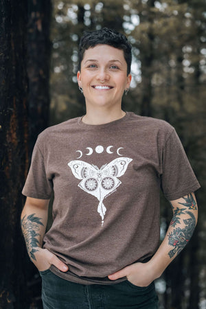 Luna Moth, Unisex T-shirt, Responsibly Made worn by a smiling person in the forest, showcasing outdoor illustrations.