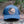 Moon and Climber, Trucker Hat on a log, featuring a faux leather patch, perfect outdoor hat for women.