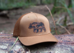Mountain Bear Trucker Hat with faux leather patch, durable, adjustable snapback, outdoor hat for women, designed in Canada.