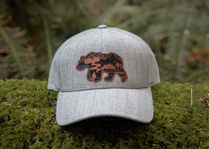 Mountain Bear Trucker Hat with faux leather patch on a grey flat bill, perfect outdoor hat for women.