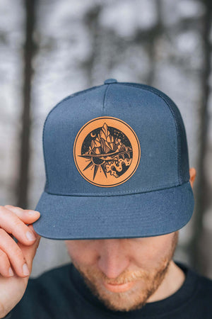 The Sea to Sky flat bill hat with faux leather patch, perfect for outdoor adventures and daily wear.