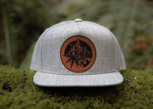 Sea to Sky flat bill hat featuring faux leather patch, perfect for outdoor adventures in style.