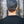 Back view of a man wearing a Sea to Sky flat bill hat in a forest setting, showcasing its adjustable snapback design.