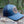 Sea to Sky Trucker Hat with faux leather patch on natural background, designed in Canada for outdoor adventures.