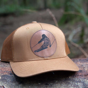 Skier, Trucker Hat featuring a faux leather patch, perfect outdoor hat for women, designed in Canada by a Canadian artist.