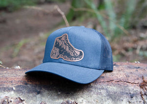 Hiking Boot, Trucker Hat with durable faux leather patch, designed for outdoor adventures in Canada.
