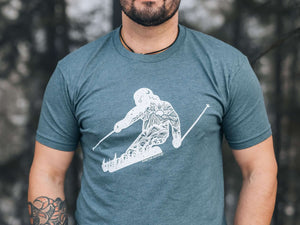 Skier, Unisex T-shirt, Responsibly Made worn by a model in a forest setting, showcasing eco friendly tshirt design.