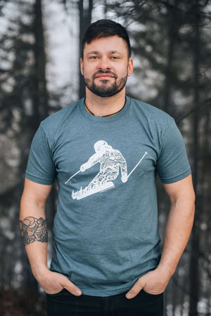 Skier, Unisex T-shirt, Responsibly Made worn by a model in a forest setting, showcasing eco friendly tshirt design.