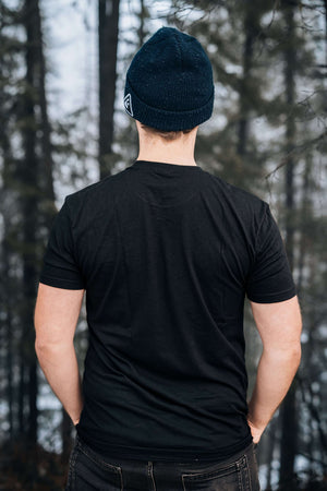 Hike More, Worry Less; Unisex T-shirt, Responsibly Made worn by a person in nature, showcasing its eco-friendly design.