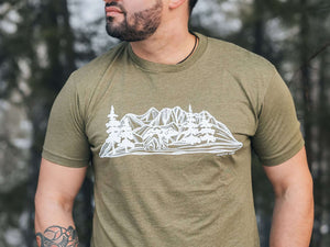 Bear and Mountain, Unisex T-shirt, Responsibly Made featured on model in forest setting, showcasing eco-friendly apparel and outdoor illustrations.
