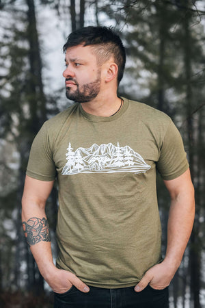 Bear and Mountain, Unisex T-shirt, Responsibly Made featured on model in forest setting, showcasing eco-friendly apparel and outdoor illustrations.