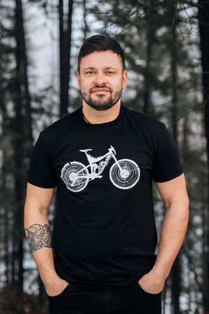 Man wearing a Mountain Bike, Unisex T-shirt, Responsibly Made, showcasing outdoor illustrations.