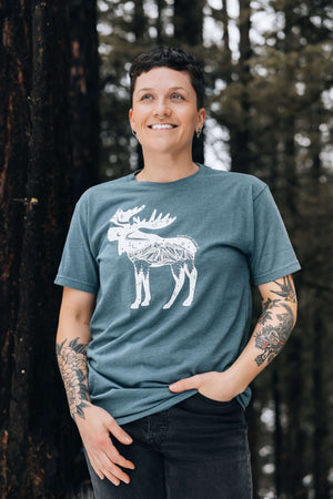 Moose, Unisex T-shirt, Responsibly Made worn by a model outdoors, showcasing premium apparel with outdoor illustrations.