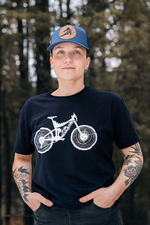 Mountain Bike, Unisex T-shirt, Responsibly Made - woman wearing black tee with bike illustration outdoors.