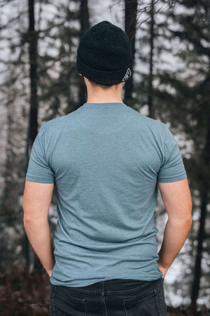 Person wearing Moose, Unisex T-shirt, Responsibly Made, in a forest setting, showcasing premium apparel.
