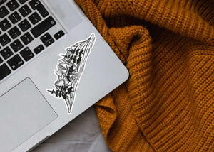 Bear and Mountain Sticker on laptop corner, a black and white outdoor sticker featuring original illustration, made in Canada.