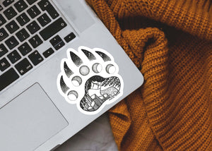 Bear Claw Sticker on laptop showcasing original illustration, durable black and white vinyl, made in Canada.