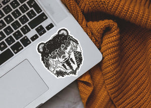Bear Head Sticker on a laptop, an outdoor vinyl sticker featuring a black and white original illustration, made in Canada.