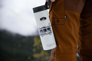 Camper Van Sticker on a travel mug, featuring a black and white original illustration, designed for outdoor adventures.