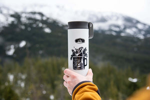 Camping Mug Sticker on a travel mug, showcasing original illustration of outdoor adventures in a beautiful mountainous setting.