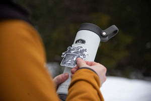 Camping Mug Sticker on a travel mug, showcasing black and white original illustration, made in Canada.