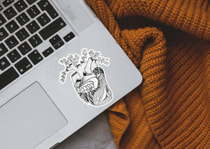 Heart Sticker on a laptop, featuring a black and white original illustration, made in Canada, showcasing nature.