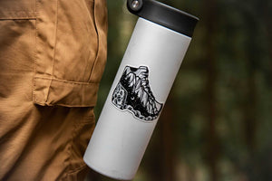Hike More, Worry Less Sticker on a water bottle, showcasing an original illustration of a hiking boot.
