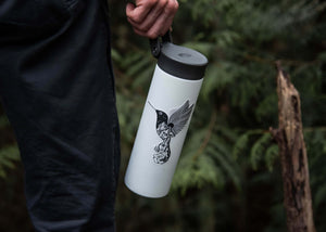 Hummingbird Sticker on a portable water bottle in a forest setting - eco-friendly, made in Canada, black and white illustration.