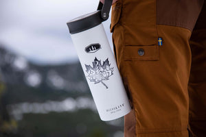 Maple Leaf Sticker Light on a white water bottle outdoors, showcasing a black and white original illustration.