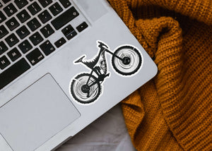 Mountain Bike Sticker on a laptop, showcasing a black and white original illustration by a Canadian artist.