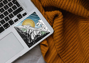 Mountain and Ocean Sticker on a laptop, showcasing an original illustration with a glossy vinyl finish.