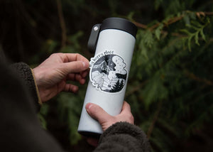 My Happy Place Sticker applied to a white travel mug, showcasing an original black and white outdoor illustration.