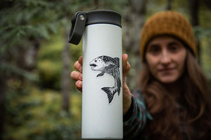 Salmon Sticker on a white water bottle held by a person in a forest, showcasing an original illustration.