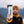 Squamish Sticker on a travel tumbler held by a man in a mountain setting, showcasing outdoor lifestyle.