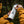 Person applying a Squamish Sticker on a white insulated tumbler in a natural outdoor setting.