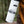 The Stawamus Chief Sticker on a white water bottle in a natural outdoor setting, featuring an original illustration.