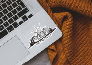 Three Sisters Mountain Sticker on a laptop, showcasing a black and white original illustration for outdoor use.