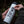 Person applying Tofino Sticker on a stainless steel tumbler, showcasing outdoor sticker design.