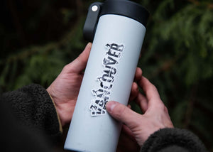 Vancouver Sticker on a travel mug held by a person, showcasing its outdoor sticker design, made in Canada.