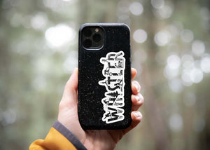 Hand holding a phone case featuring a Whistler Sticker, a black and white outdoor vinyl sticker with original illustration.